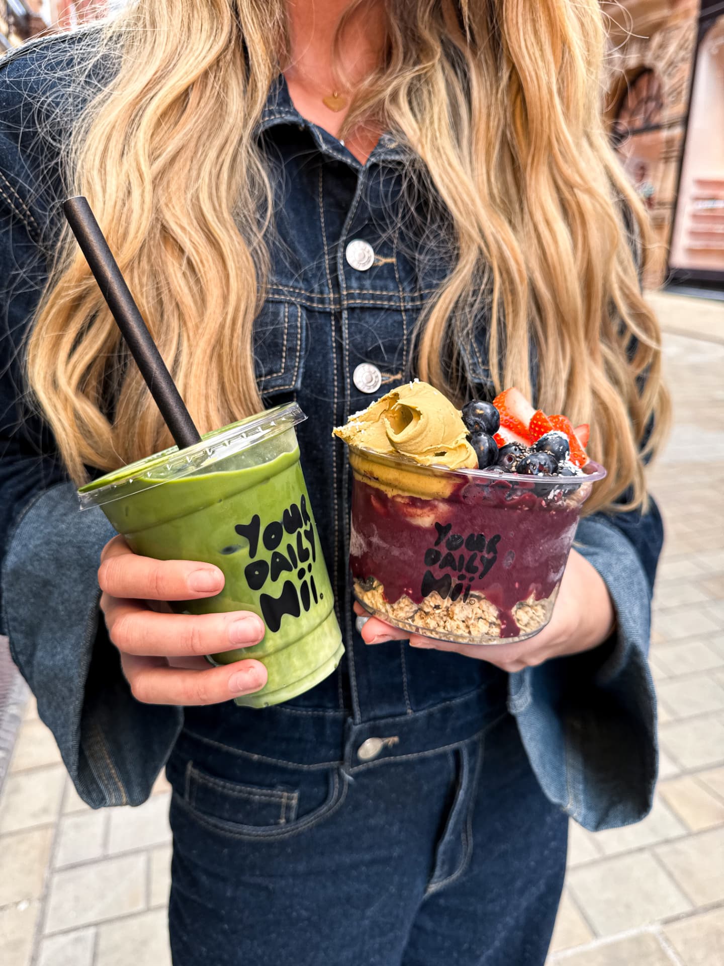 Matcha smoothie and acai bowl held outside a Leeds cafe, shot on iPhone
