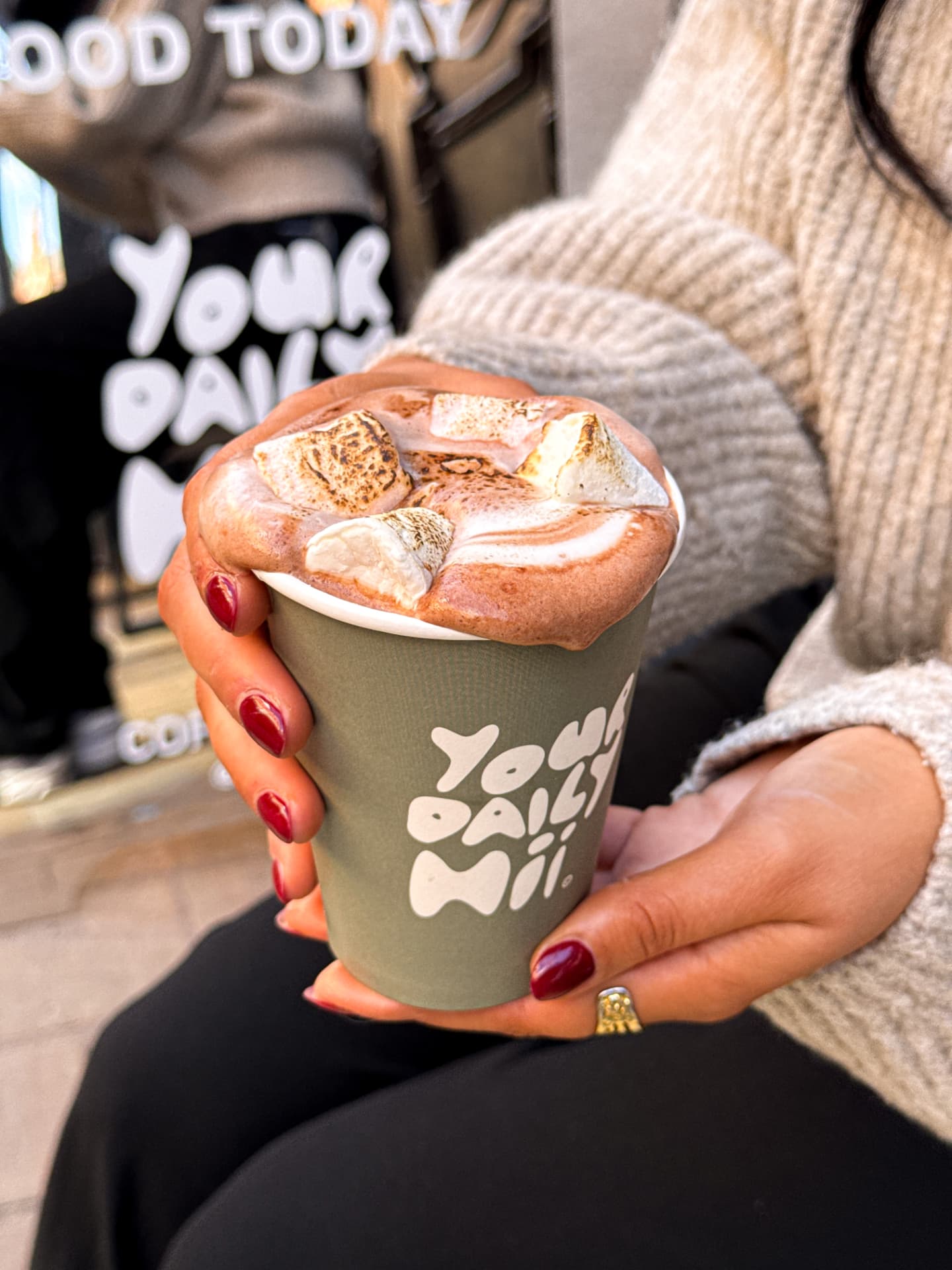 Hot chocolate with toasted marshmallows held outside a Leeds cafe