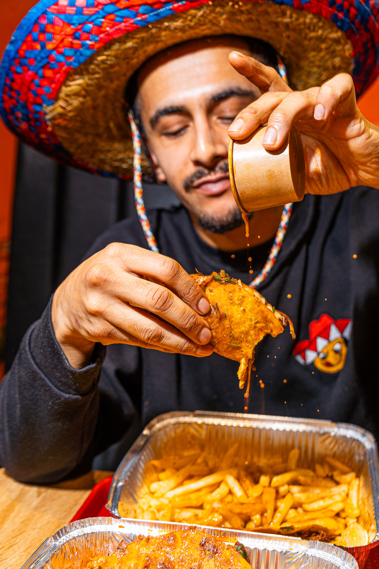 Consommé poured over a birria taco, Mexican food photography
