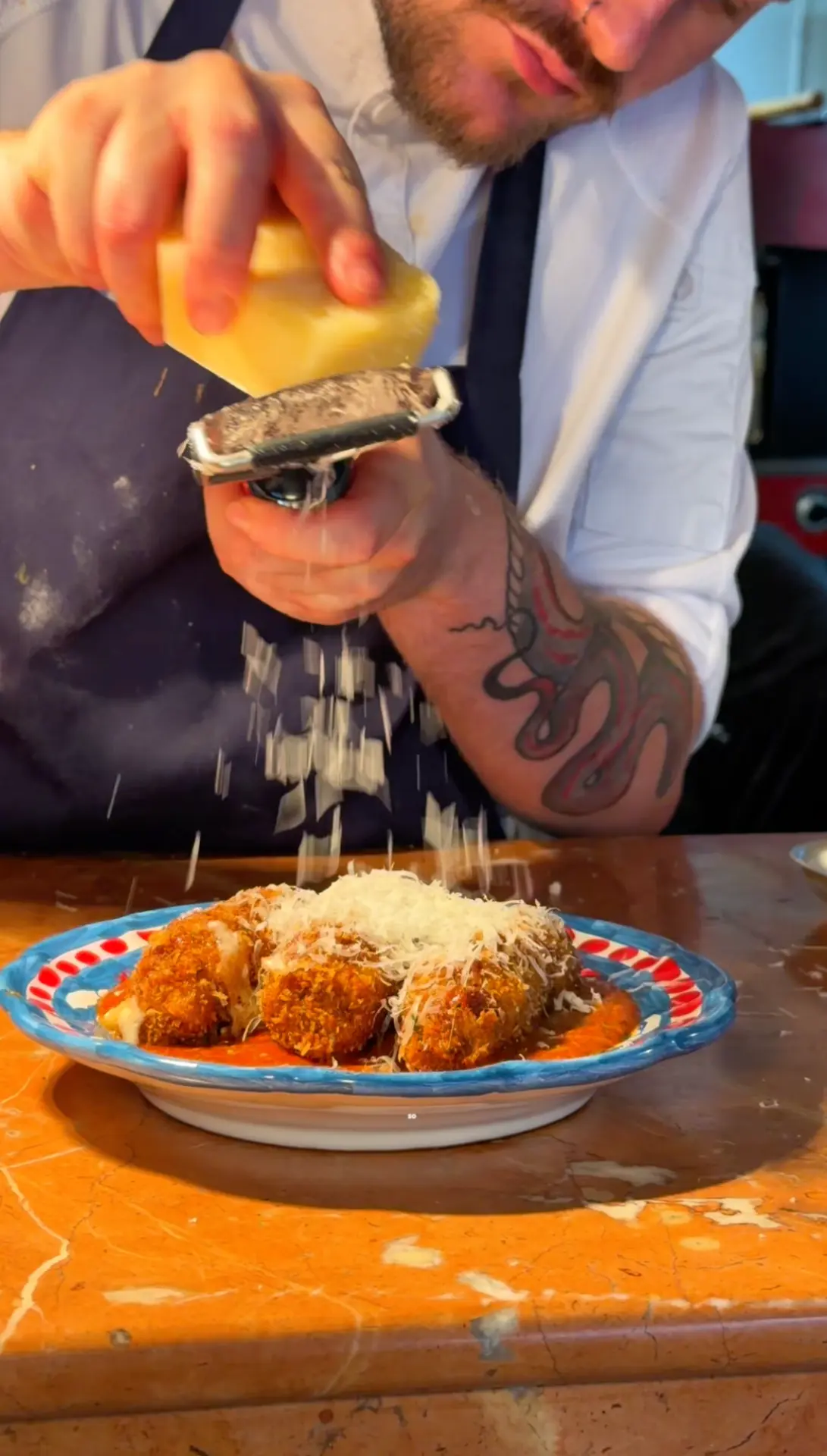 Chef grating cheese over fresh pasta in a Leeds restaurant reel