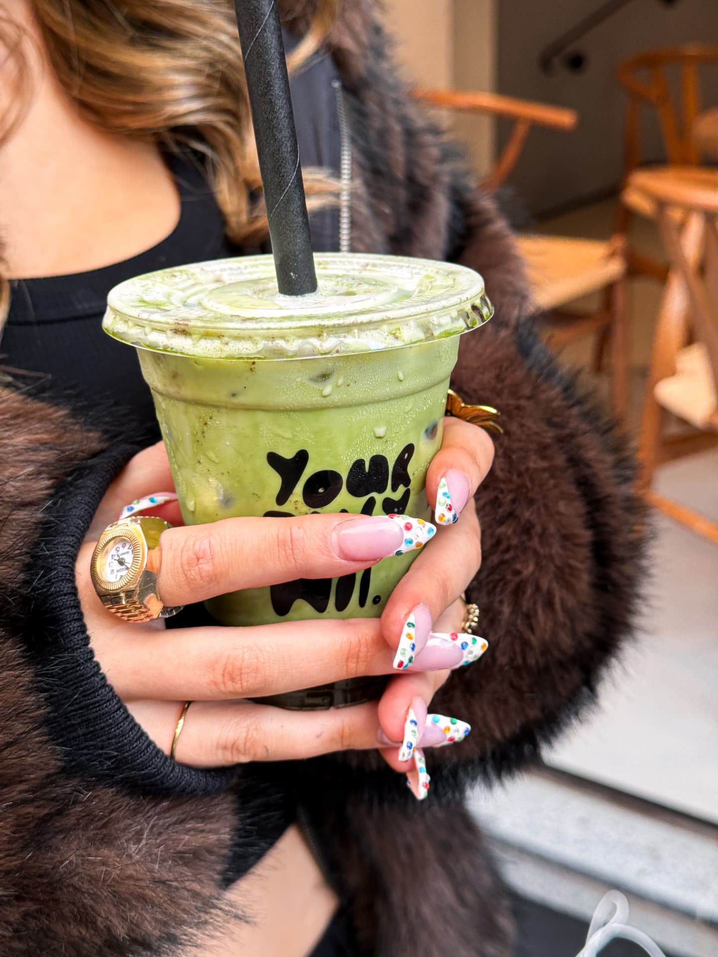 Iced matcha latte held in a Leeds cafe, shot on iPhone