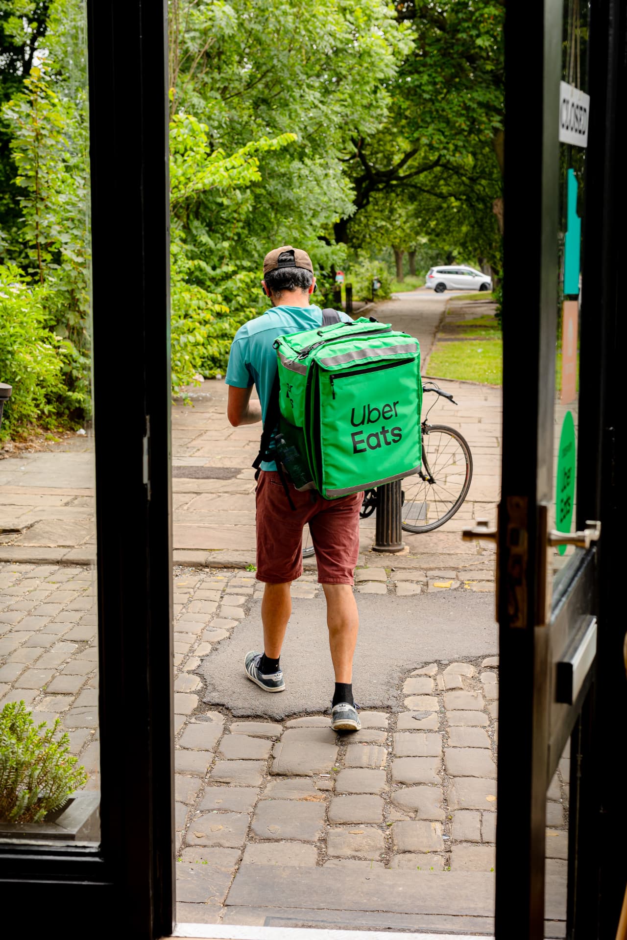 Uber Eats rider collecting an order, delivery app content shoot